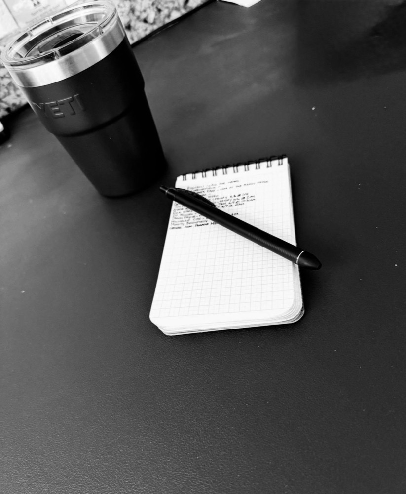 A field notebook and pen on a desk, where every fundraising plan starts