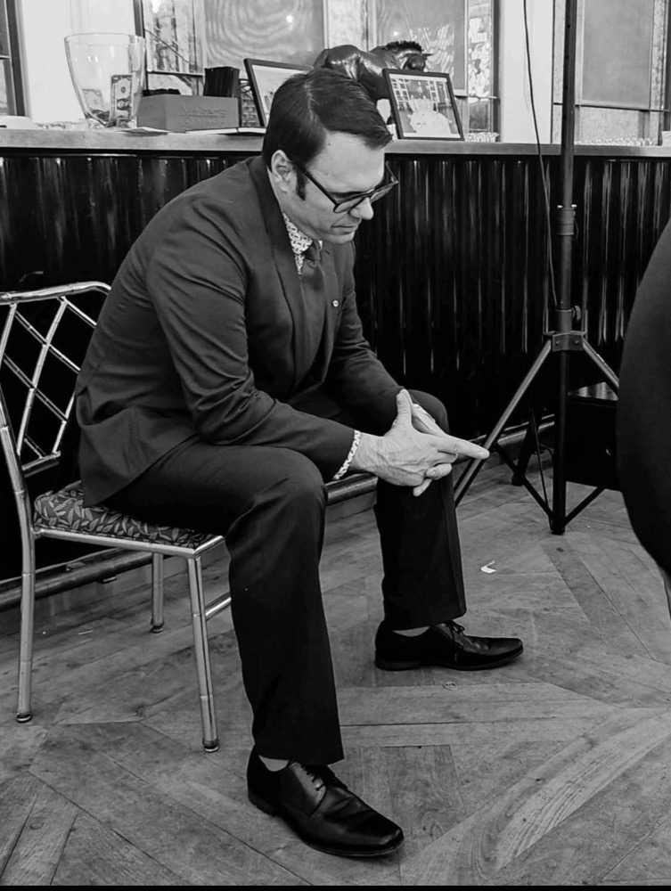 George Ricciardella listening during a conversation at an event